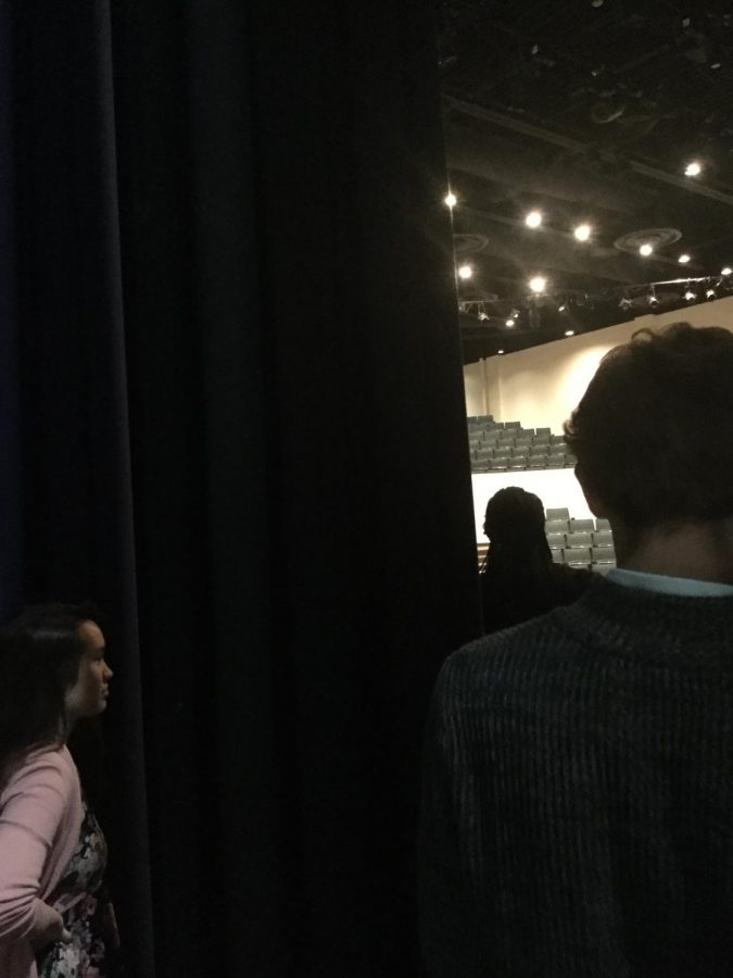 Junior, Layne Eklund, and seniors, Dominic Scheerer and Michelle Tabansi stay attentive backstage to make sure not miss their cue.