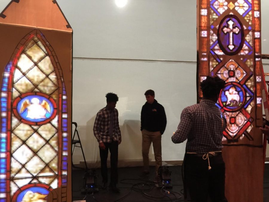 Senior, Jelani Nicol (leftmost student), stage manager, is keeping order amidst the multiple tasks that need to get done for the play coming up soon.