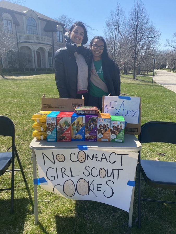Shylee, 22', sells Girl Scout cookies with her sister outside of her home.