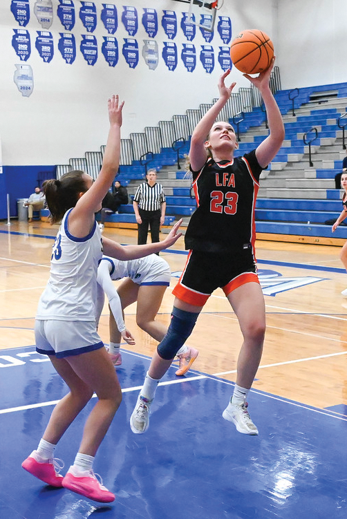 Lilla Szilvassy ‘25 goes for a lay-up above her opponent.