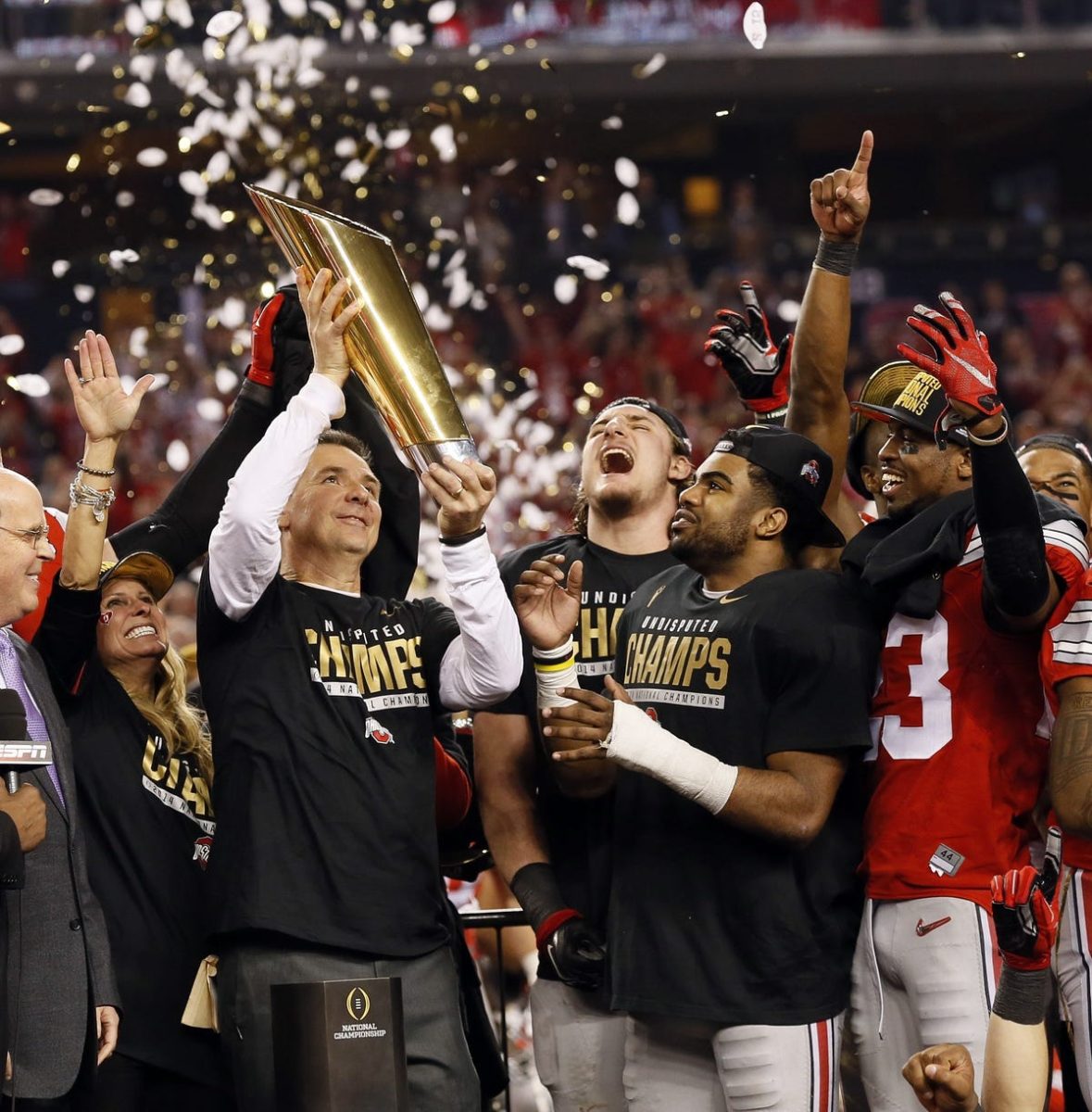 Ohio State head Coach Ryan Day hoists the National Championship trophy alongside his team. (Courtesy of Columbus Dispatch)