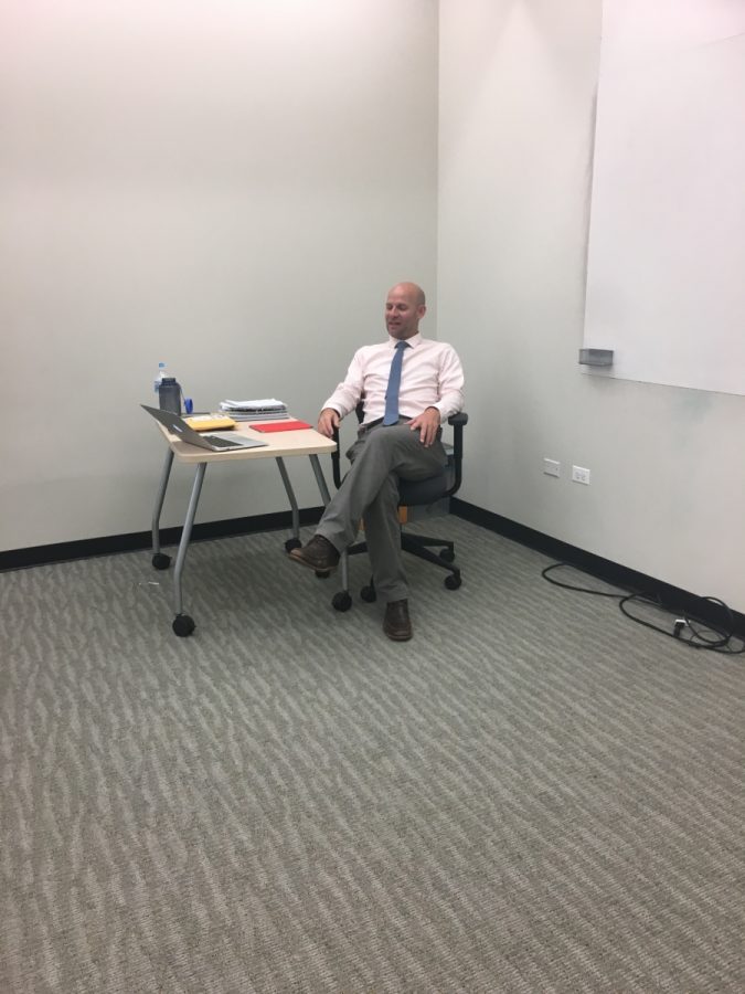 Before starting a day of Calculus class, Mr. Paul Makovec jokes around with students to  ease their way from their past class.