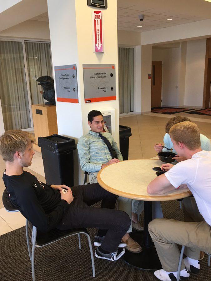 Some team members gather around for a quick pre-game meal.