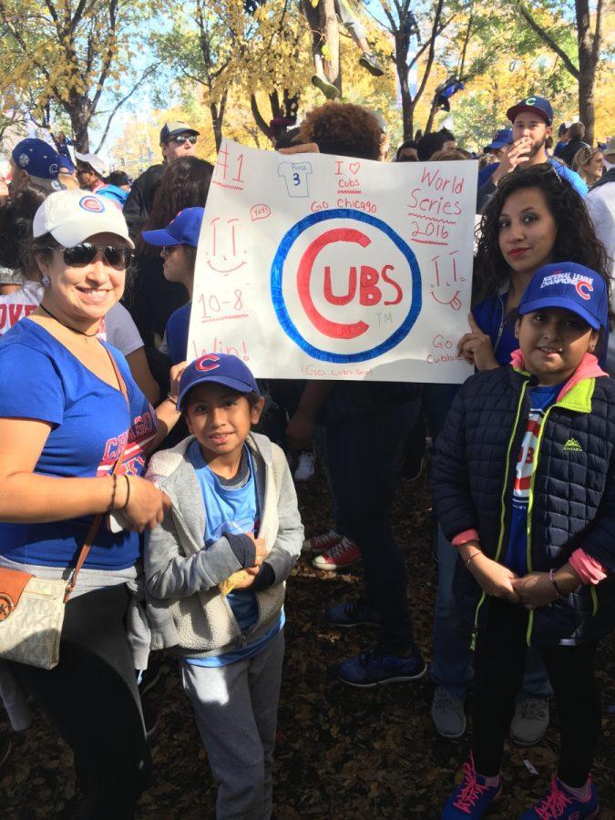 Fans wait patiently for the parade to start with supporting posters 