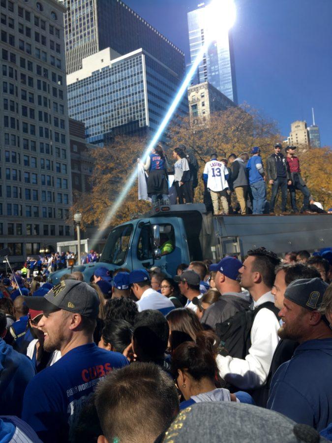 People climbing on cars and trucks to try to get out faster from a main crowded places