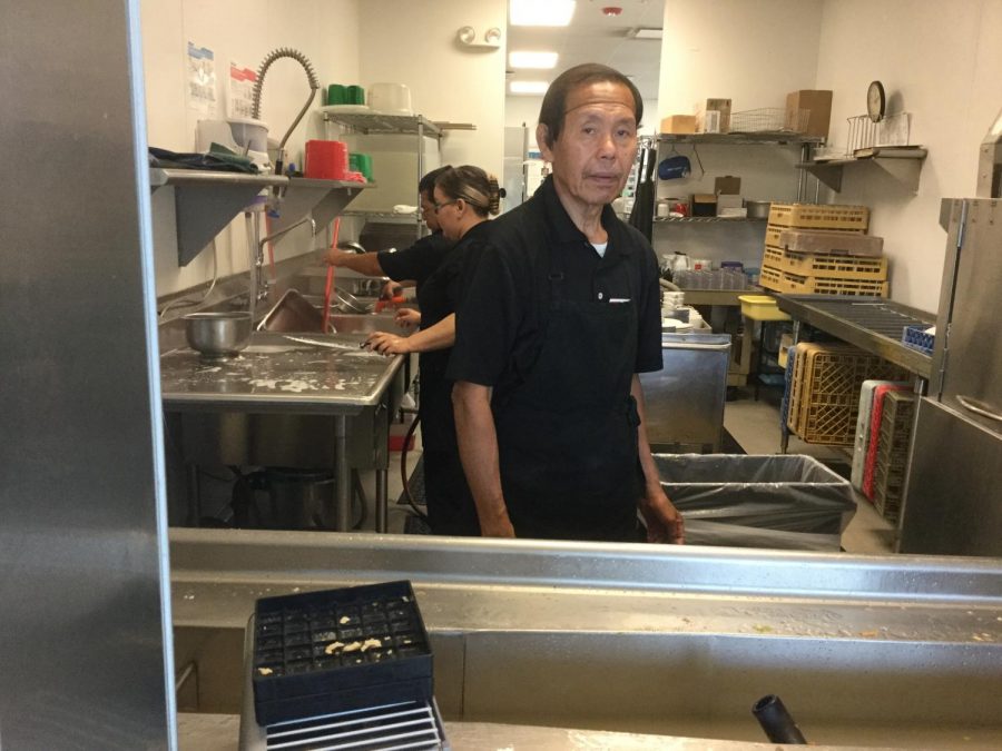 Adelardo De Castro waits for students to hand him dishes to be cleaned.
