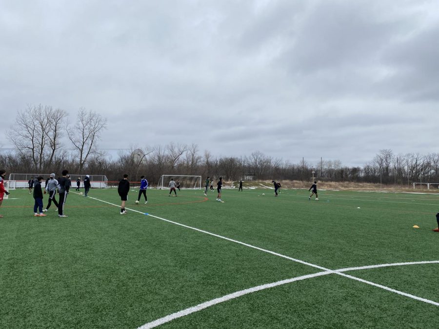 Boys' Varsity Soccer practices outside in preparation for upcoming games. 