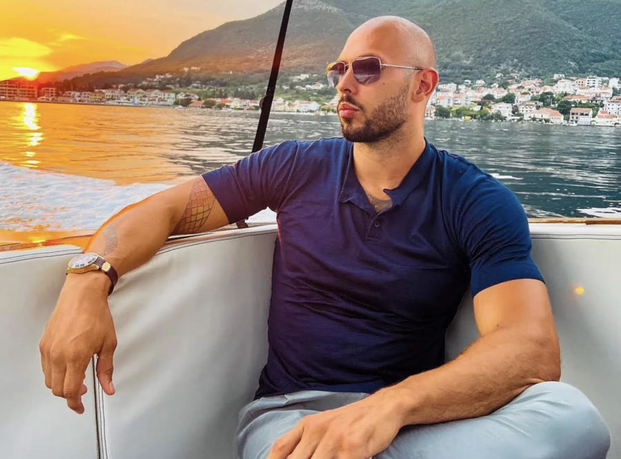 Tate poses for a photograph on a boat.