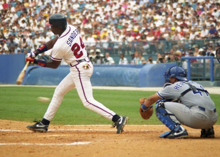 Barry Sanders swings bat.
