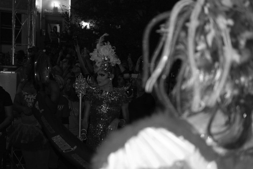 a drag queen in a fabulous gown under the spotlight.