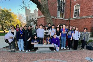 The Math Team poses together with their first-place state championship trophy at Illinois State University. 