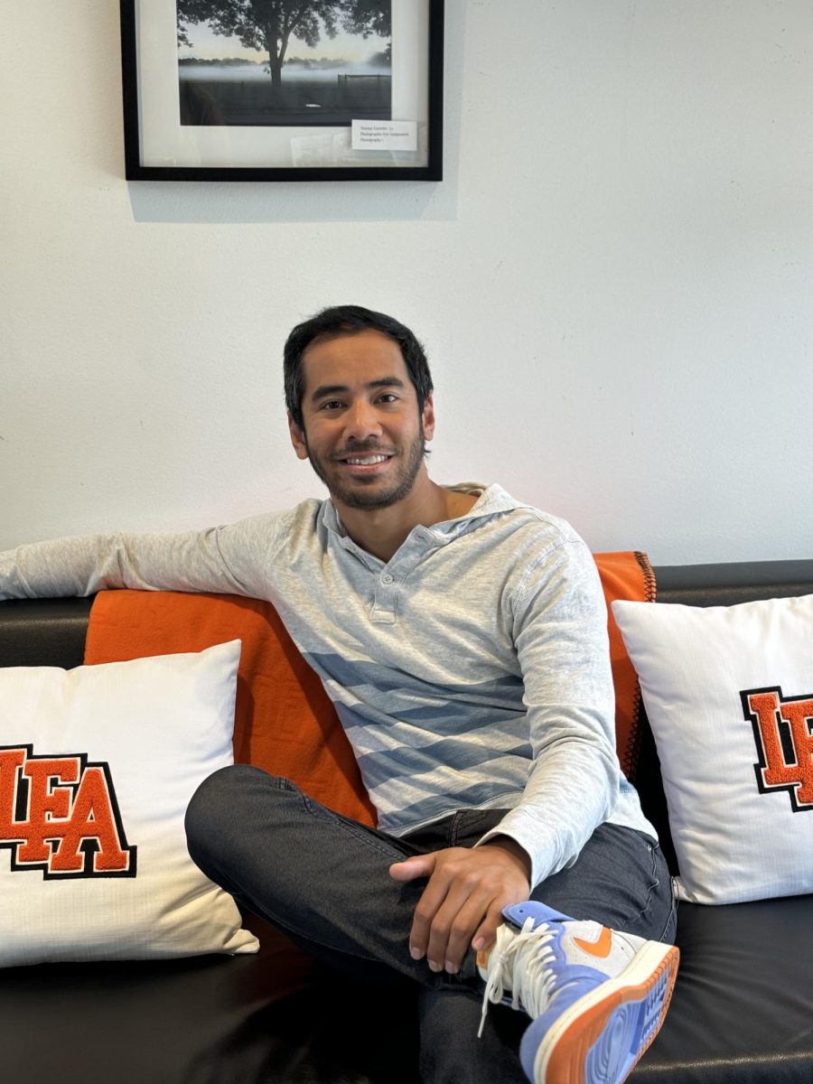 Dave Atas poses on a couch in his new office. 