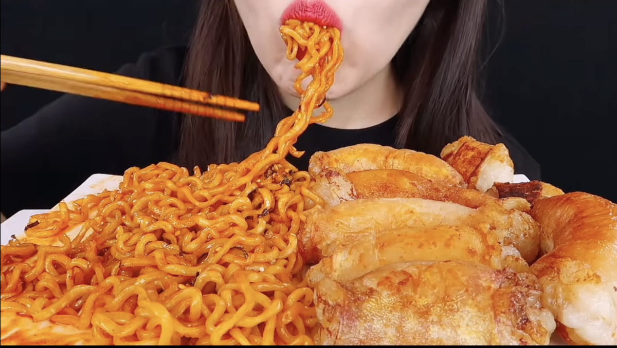 A picture that features @zoey_asmr eating noodles for a mukbang.