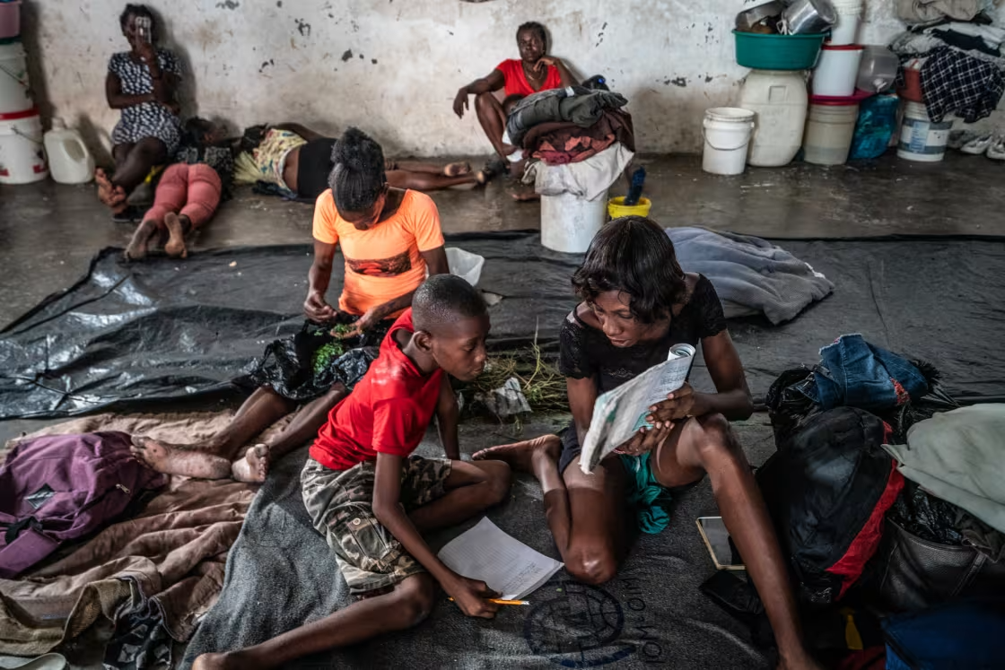 Haitians seek shelter from gang violence in an old boxing arena.