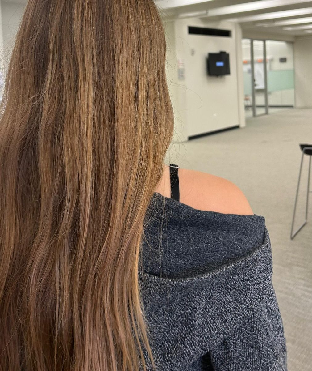 A student wears an off-the-shoulder top with a bra strap exposed.