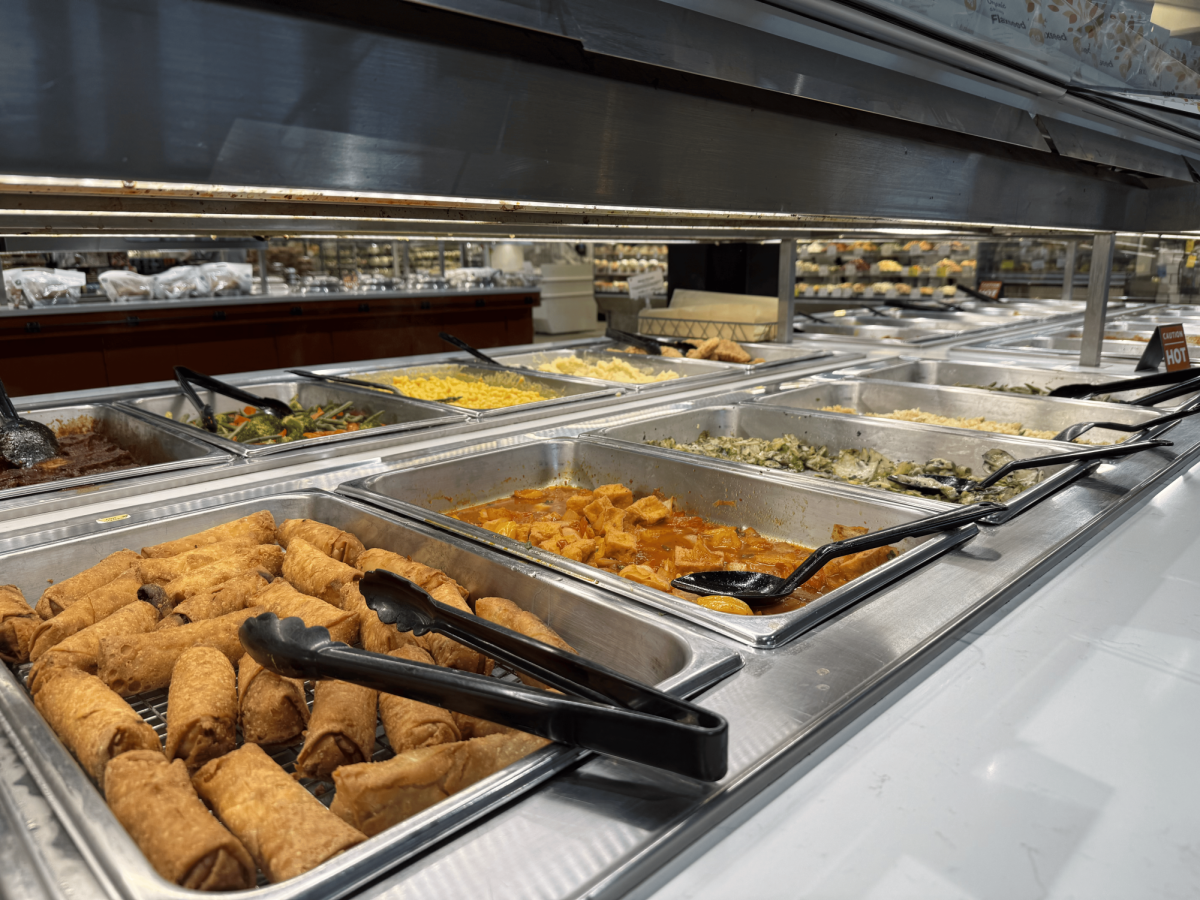 Whole Foods features a buffet with a variety of foods avaliable for customers to choose.