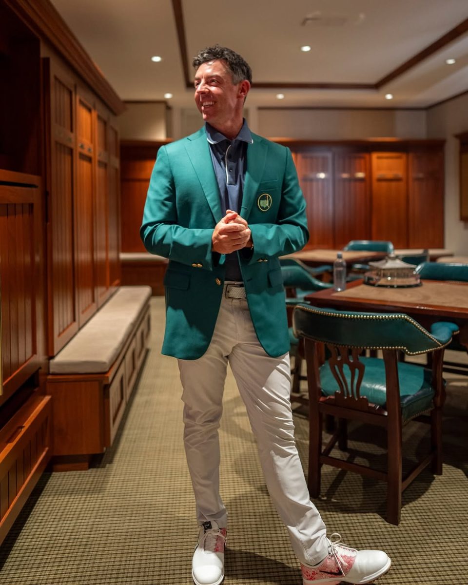 Rory McIlroy poses with his green jacket after winning The Masters.
