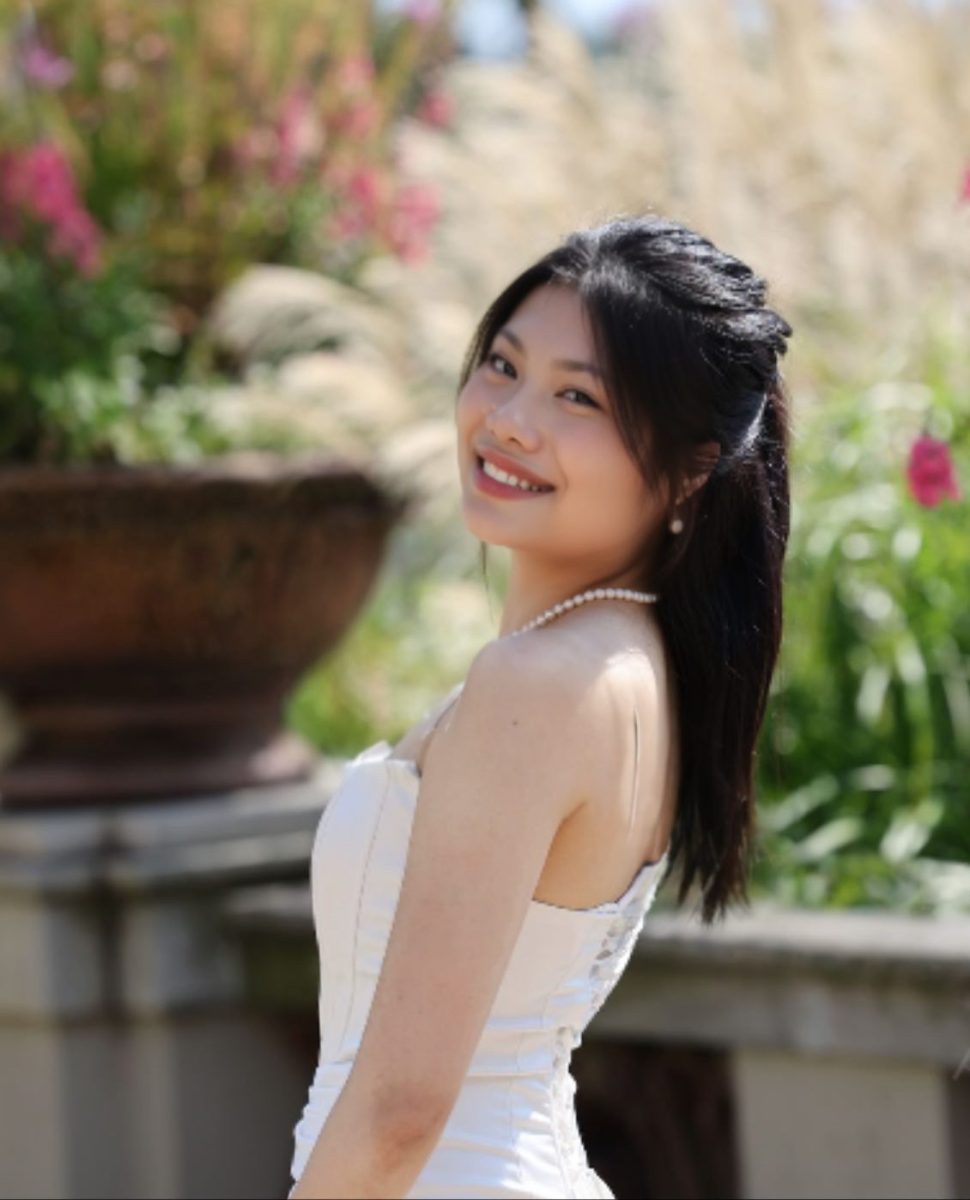 Bao Le ‘25 poses in the Formal Garden for her senior picture outside of Reid.