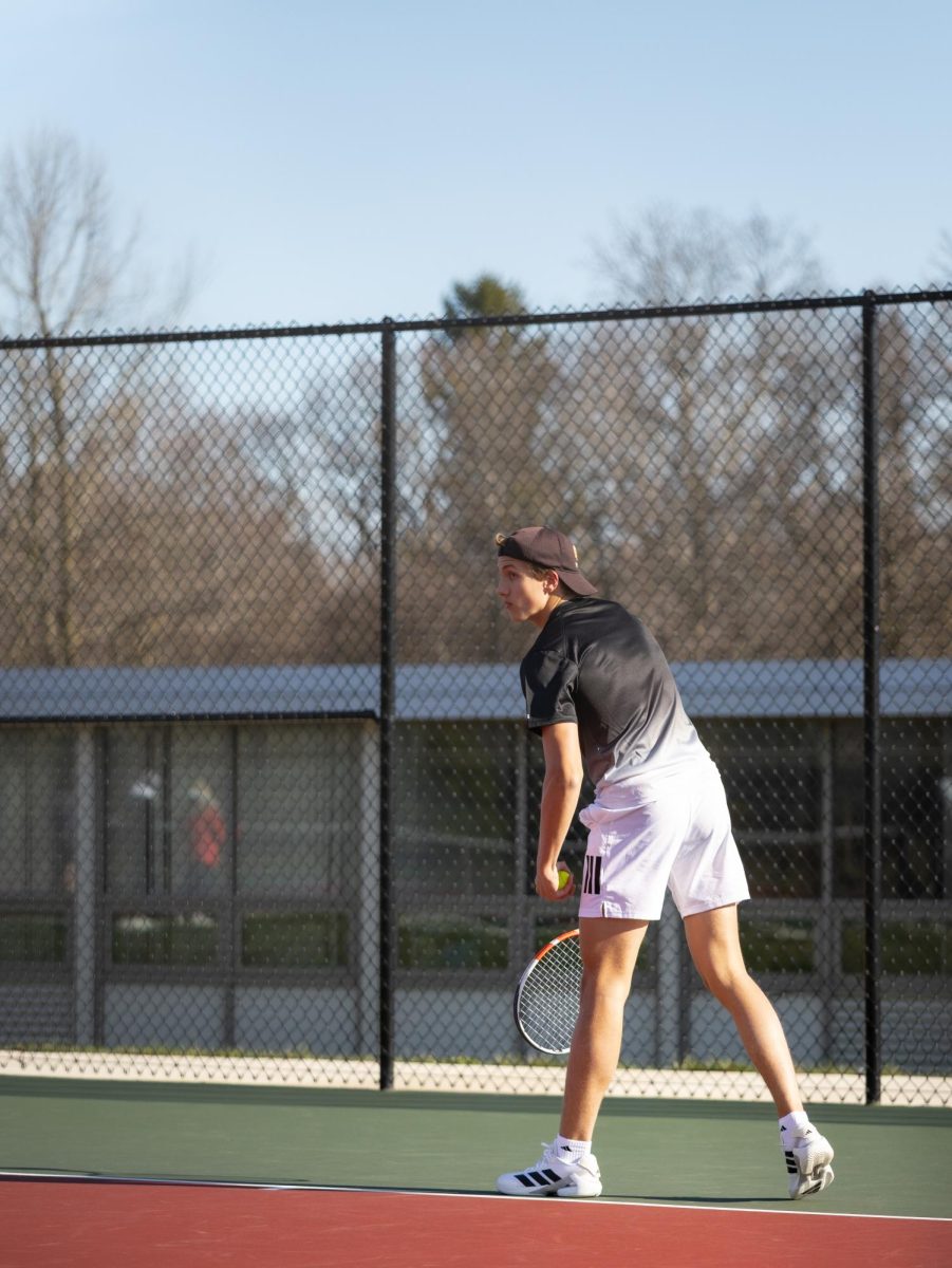 Carson Emery ‘25 prepares to serve.