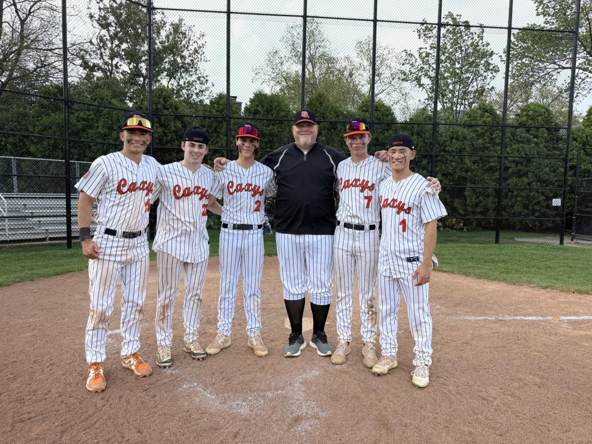 Coach Mike Hall poses with seniors at the last game of the season.