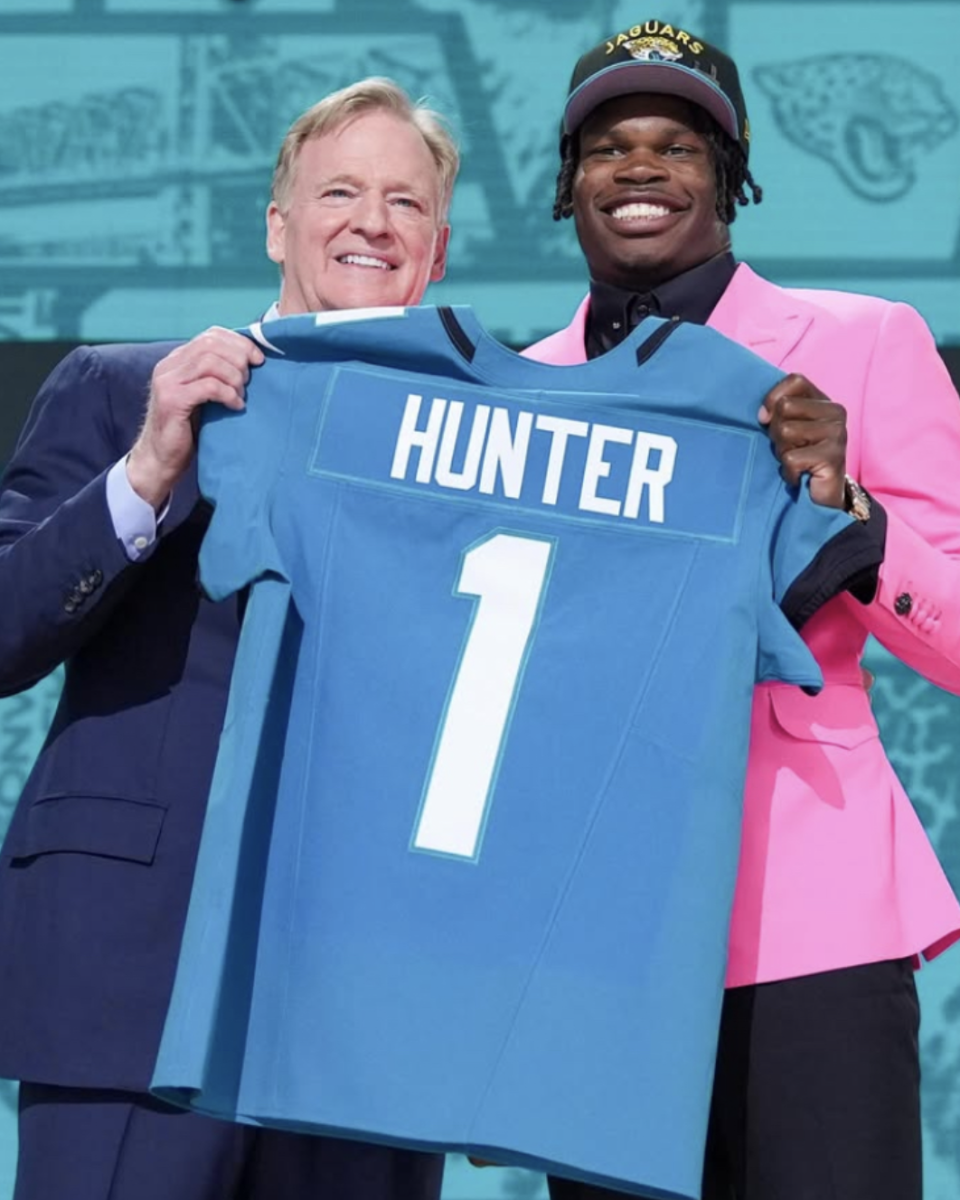 No. 2 overall pick Travis Hunter poses for his draft photo with NFL Commissioner Roger Goodell.