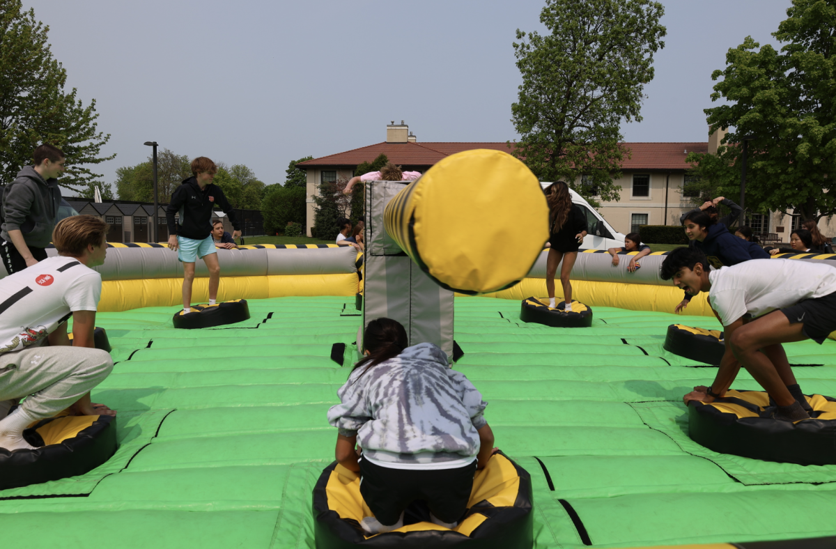 Students play on the inflatables on the quad.