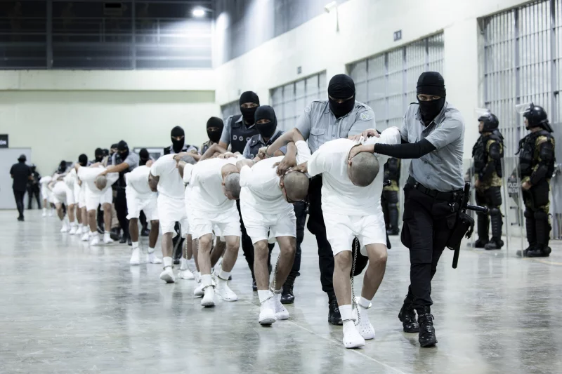 CECOT prison guards process U.S. deportees.