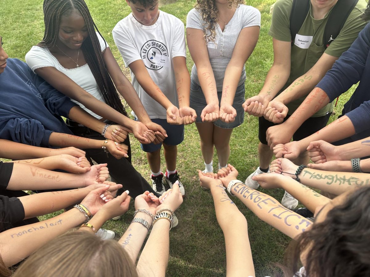 Freshmen extend their arms, revealing adjectives describing themselves. (Courtesy of the LFA Marketing and Communications Office)
