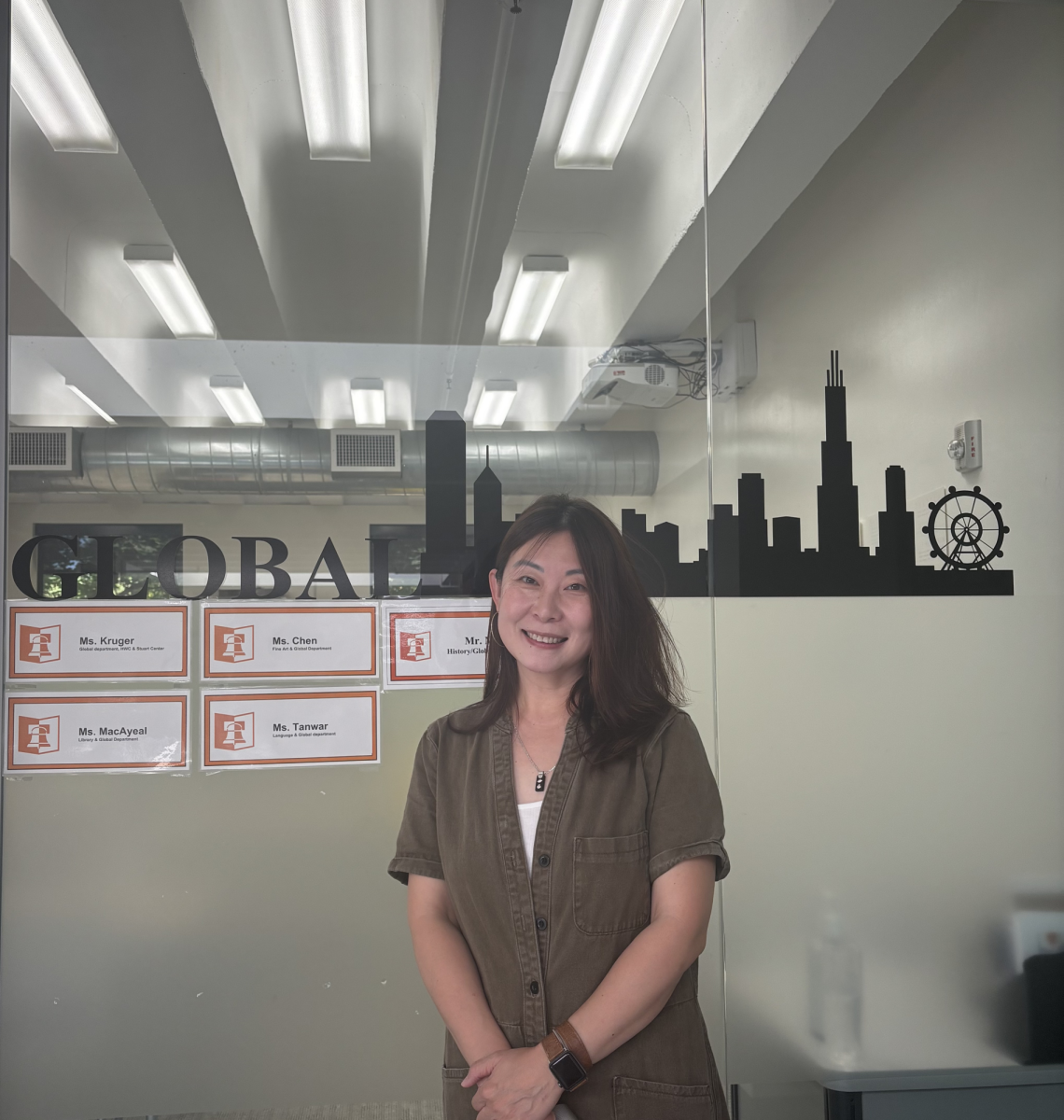 Yue Chen poses in front of the global classroom in Upper Corbin.