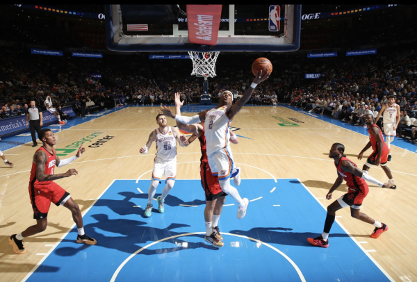 2025 MVP Shai Gilgeous-Alexander goes for a layup against the Houston Rockets in a preseason game. 
