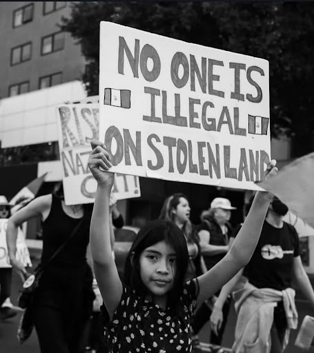 A girl protests against mass deportations in the street.