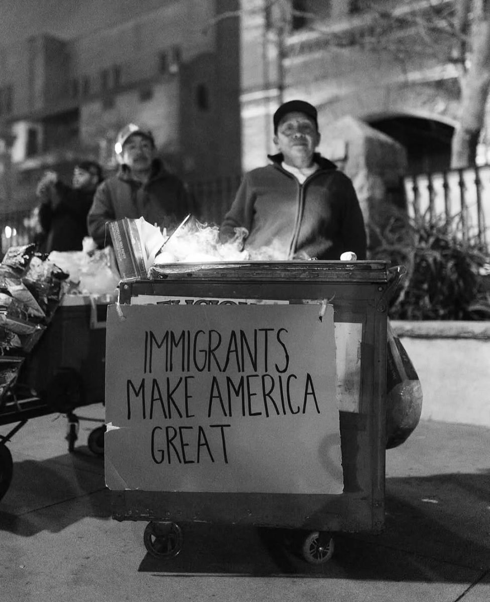 Street food owners stand behind a sign as an act of protest.