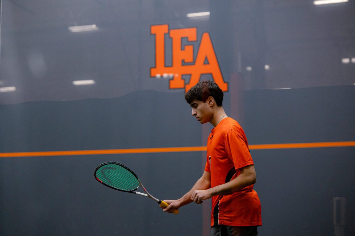 Hamza Jafri '26 plays in his squash match.
