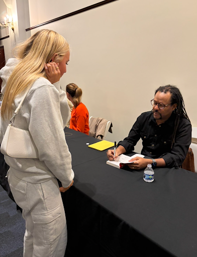 Colson Whitehead signs a copy of his book, "The Underground Railroad."
