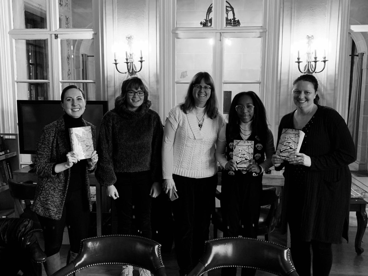 Members of the book club pose with past reads.