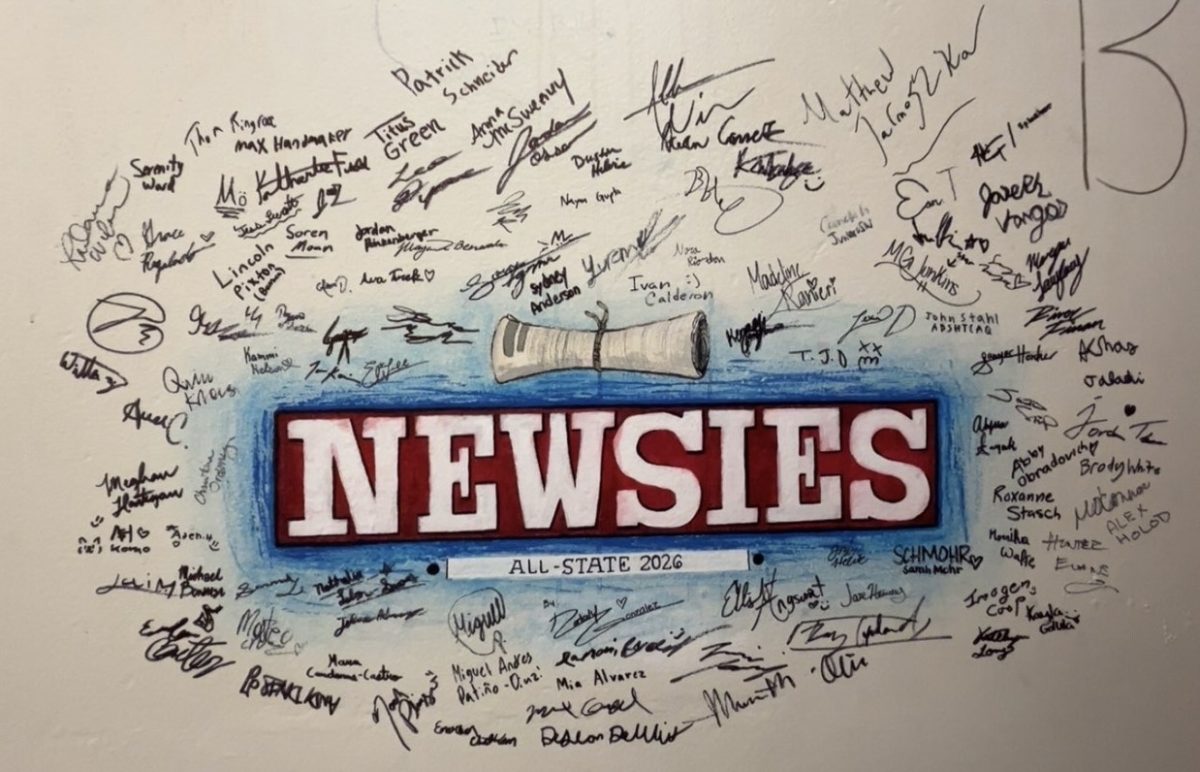 The signatures of the Newsies cast on a wall together at the festival.