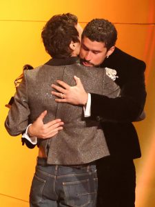 Harry Styles hugs Bad Bunny while presenting his Album of the Year award.