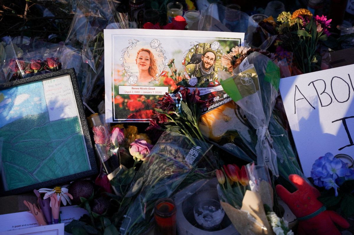 Flowers lay at a makeshift memorial site for Renee Good and Alex Pretti in Minneapolis, Minnesota.