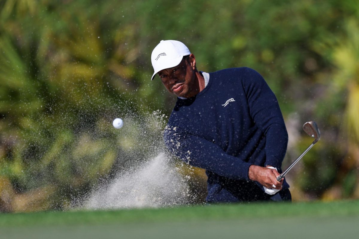 Dec 21, 2024; Orlando, Florida, [USA]; Tiger Woods hits out of the bunker on the fourth hole during the PNC Championship at The Ritz-Carlton Golf Club.