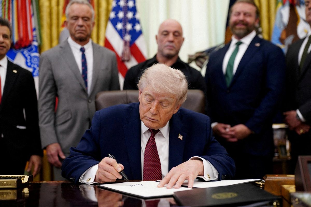 U.S. President Donald Trump signs an executive order encouraging more research into ibogaine in the Oval Office of the White House in Washington, D.C., April 18, 2026. 