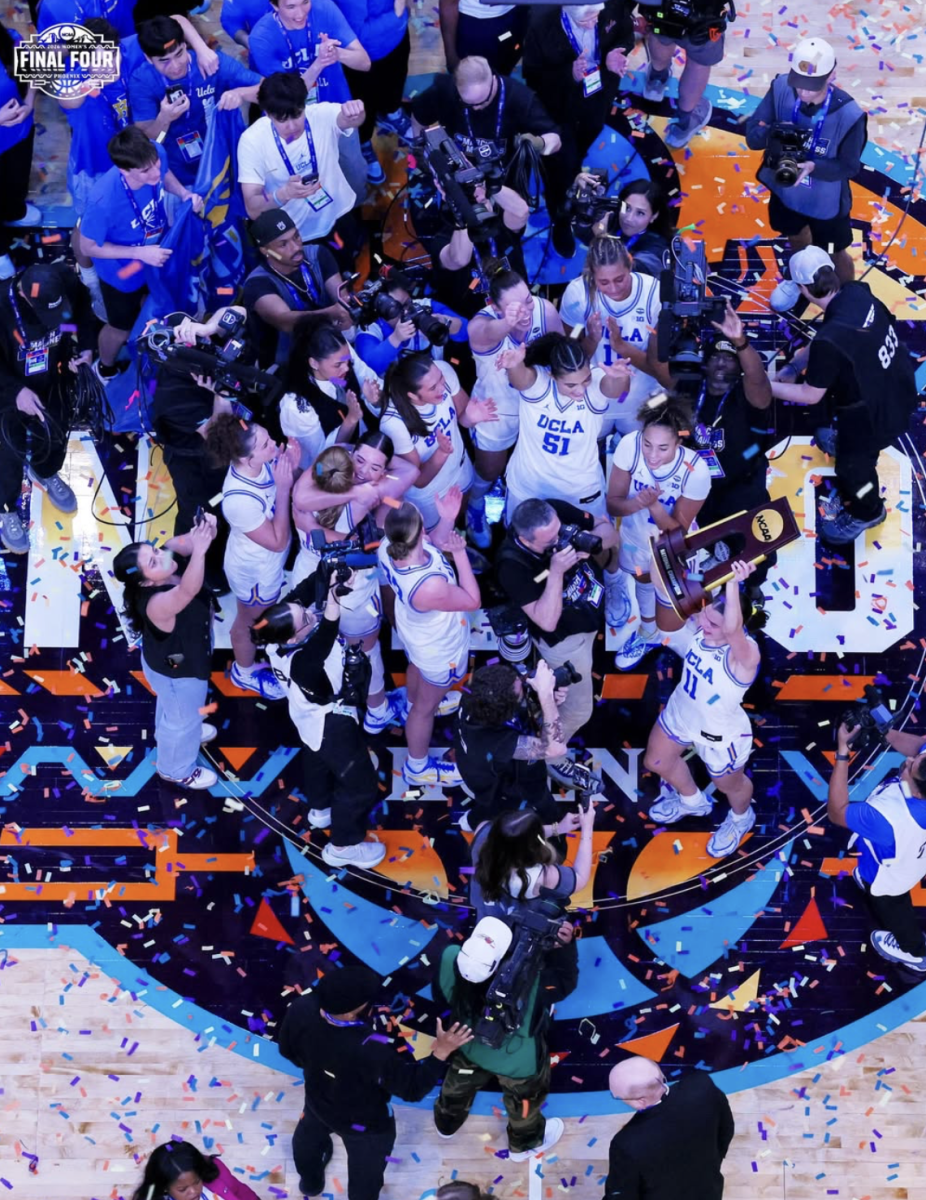 UCLA Bruins celebrate as they hoist the national championship trophy following their dominant 79-51 victory over the South Carolina Gamecocks. (Courtesy of @wfinalfour on Instagram)